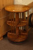 Burr wood circular revolving two tier bookcase, 53cm diameter by 77cm.