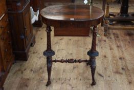 Victorian oval rosewood sewing table, the lid enclosing fretwork lidded compartments,