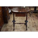 Victorian oval rosewood sewing table, the lid enclosing fretwork lidded compartments,