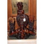 Nine Eastern wood carvings including pair of lions, bust and figures.