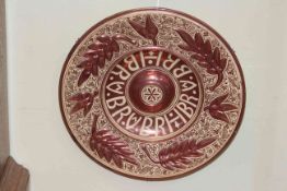 Late 19th Century lustre plaque in De Morgan style, the border with moulded leaves, 42cm diameter.