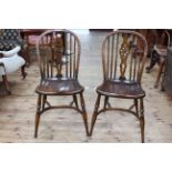 Set of four wheelback dining chairs with crinoline stretchers.