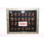 Framed collection of 25 Coca Cola badges for 1992 Spanish Olympics.