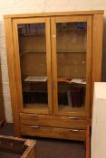 Contemporary light display cabinet having two glazed panel doors above two long drawers 129cm by