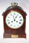 Mahogany mantel clock with French striking movement, having brass handle and splayed feet, 33cm.