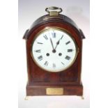 Mahogany mantel clock with French striking movement, having brass handle and splayed feet, 33cm.