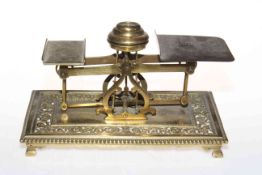 Late Victorian brass postal scales having ornate pierced base with bead border.