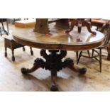 Victorian mahogany shaped oval top loo table on four carved and scrolled central supports to four