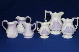 Six Samuel Alcock lavender on white Parian graduated jugs with Arab figures;