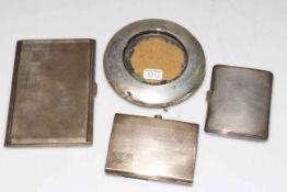 Three silver engine turned cigarette cases and small photograph frame.