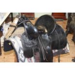 Black leather Western saddle, circa 1896, together with accessories.