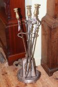 19th Century set of steel and brass fire irons with stand, having ornate handles.