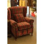 Wing armchair in tartan fabric.