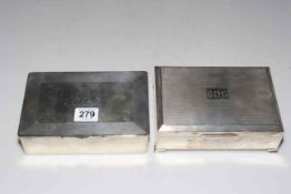 Two silver engine-turned cigarette boxes, each 17cm across.