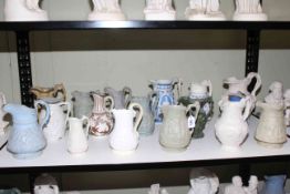 Collection of seventeen Victorian relief moulded jugs including large Copeland Parian putti and