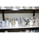 Collection of seventeen Victorian relief moulded jugs including large Copeland Parian putti and