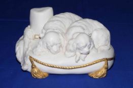 Copeland Parian Cavalier's Pets, snuggled on cushion with gilt rope and tassels, 21cm across.