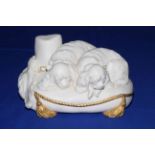 Copeland Parian Cavalier's Pets, snuggled on cushion with gilt rope and tassels, 21cm across.