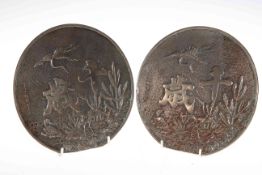 Two Japanese bronze circular plaques decorated with storks in foliage and character marks,