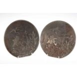 Two Japanese bronze circular plaques decorated with storks in foliage and character marks,