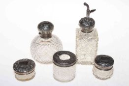 Collection of five ornate silver mounted toilet bottles including two scent bottles.