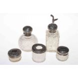 Collection of five ornate silver mounted toilet bottles including two scent bottles.