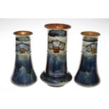 Garniture of three Royal Doulton stoneware vases,