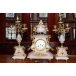 Three piece onyx and gilt metal clock garniture.