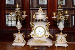 Three piece onyx and gilt metal clock garniture.