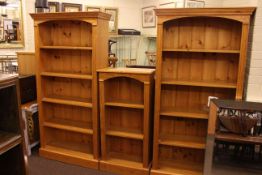 Set of three pine open bookcases, two large and one small (larger pair 184cm by 92cm,