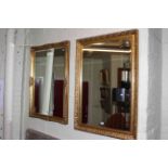 Two rectangular gilt framed bevelled wall mirrors.