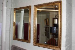 Two rectangular gilt framed bevelled wall mirrors.