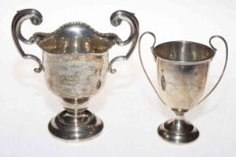 Two small silver trophy cups.