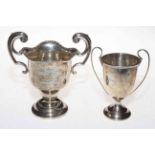 Two small silver trophy cups.