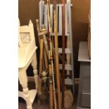 Fishing rods, garden tools, pair steps and tin trunk.