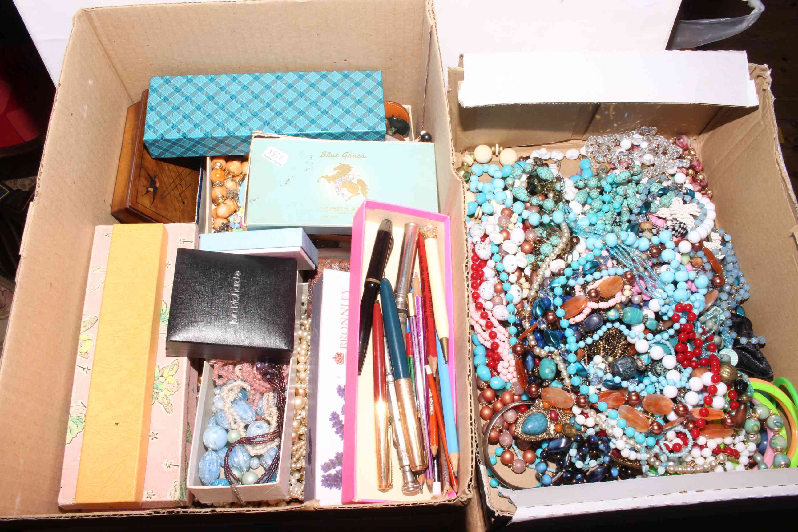 Two boxes of costume jewellery.