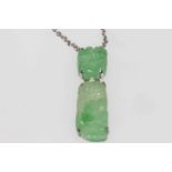 Foliate carved jade pendant in two pieces mounted and with platinum fine chain necklace, boxed.