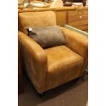Tan distressed leather armchair and nest of three glass and gilt tables.