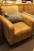 Tan distressed leather armchair and nest of three glass and gilt tables.