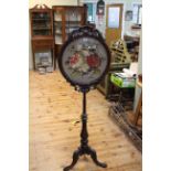 Victorian mahogany tripod pole screen with oval adjustable glazed needlework panel.