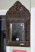 Antique embossed brass framed wall mirror, 57cm by 31cm.