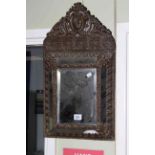 Antique embossed brass framed wall mirror, 57cm by 31cm.