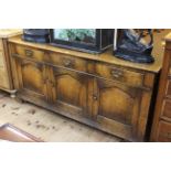 Period style oak dresser having three drawers above three arched fielded panel doors, 79cm by 168cm.