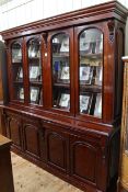 Victorian style mahogany cabinet bookcase having four arched glazed panel doors above four drawers