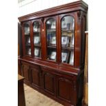 Victorian style mahogany cabinet bookcase having four arched glazed panel doors above four drawers