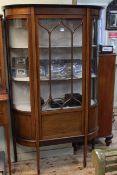 Edwardian mahogany and string inlaid shaped front single door vitrine, 176cm by 107cm.