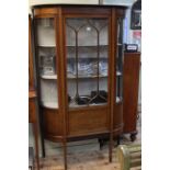 Edwardian mahogany and string inlaid shaped front single door vitrine, 176cm by 107cm.