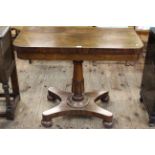 Victorian rosewood fold top card table raised on turned pedestal to inverted quadriform base,