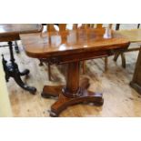 Victorian mahogany fold top card table raised on turned pedestal to inverted quadriform base, 73.