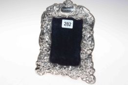 Ornate silver mounted easel photograph frame, shaped and embossed with foliage, maker RH,